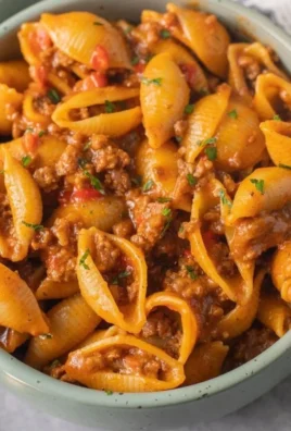 High protein taco pasta bowl garnished with fresh herbs and cheese