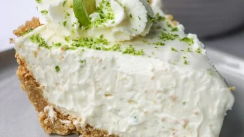 No Bake Key Lime Pie made with condensed milk, topped with lime slices and whipped cream.
