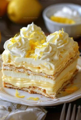 No-bake lemon eclair cake topped with lemon glaze and sliced lemons