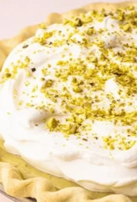 Deliciously crafted Pistachio Cream Pie with a creamy filling and nutty crust.