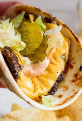 Delicious smash burger taco topped with creamy burger sauce