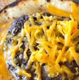 Smashed cheeseburger tacos served with toppings and fresh ingredients.