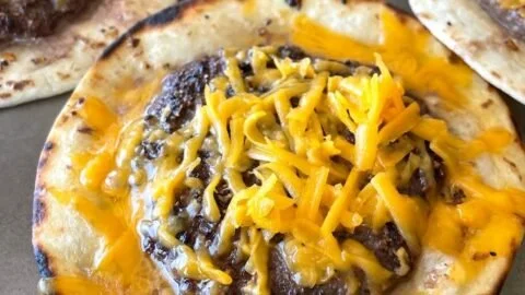 Smashed cheeseburger tacos served with toppings and fresh ingredients.