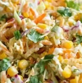Bowl of spicy corn slaw with fresh vegetables and vibrant colors