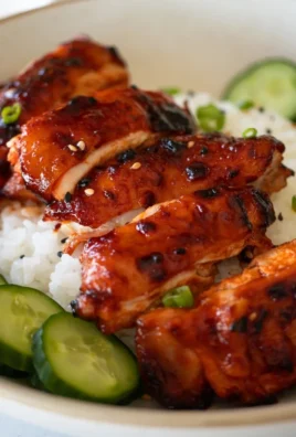 Sticky Honey Gochujang Chicken with colorful veggies and glaze on a plate