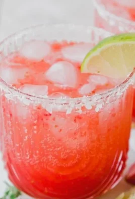 Strawberry Lime Mocktail Margarita garnished with fresh strawberries and lime