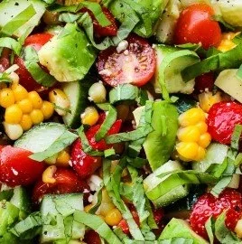 Summer salad featuring corn, strawberries, and avocado in a vibrant dish