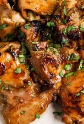 Grilled Thai chicken marinated with herbs and spices, served on a plate.