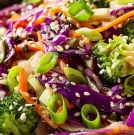 Vibrant Asian cabbage salad with sesame ginger dressing in a colorful bowl