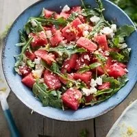 Vibrant watermelon salad with arugula, feta cheese, and fresh herbs