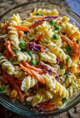 Bowl of addictive Crack Pasta Salad garnished with fresh herbs