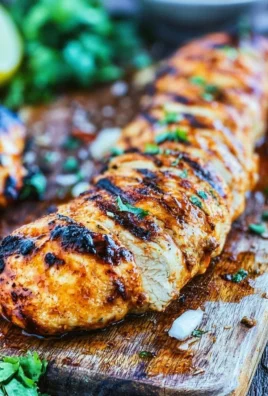 Marinated BBQ chicken ready for the grill, showcasing vibrant spices and herbs.