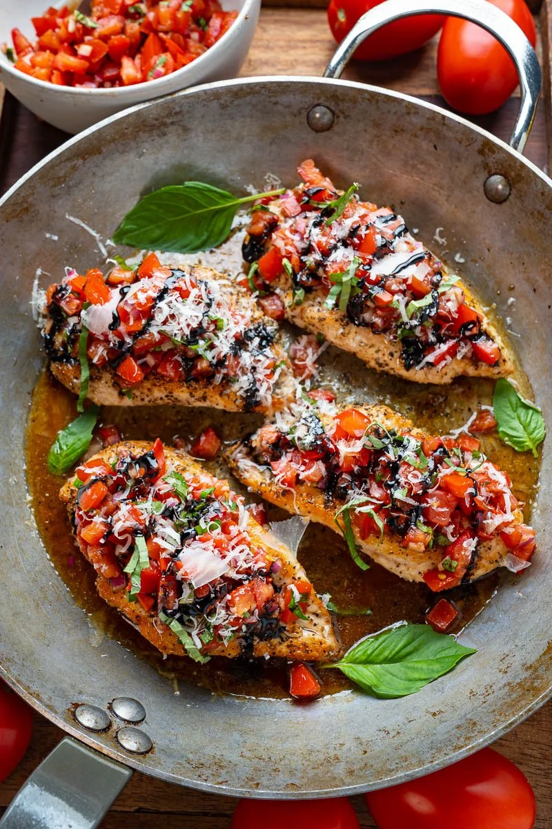 Delicious Bruschetta Chicken topped with fresh tomatoes and basil