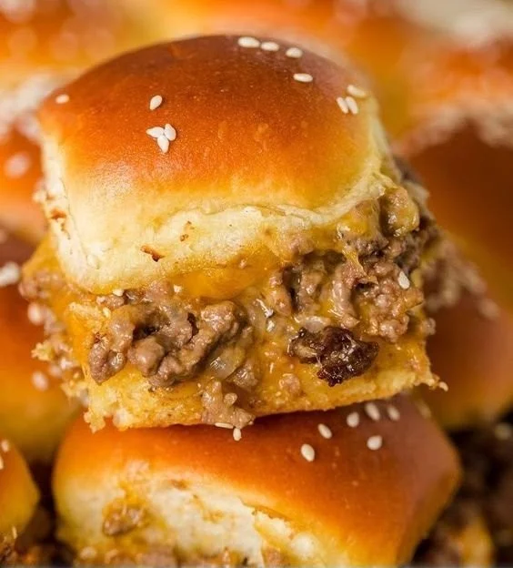 Delicious cheeseburger sliders served on a platter with toppings
