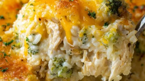 Cheesy broccoli chicken and rice casserole in a baking dish.