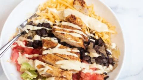 Delicious Chicken Burrito Yumm Bowls ready to eat, filled with fresh ingredients.