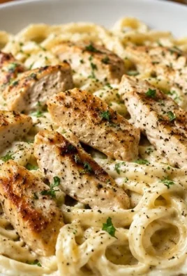 Delicious creamy garlic chicken pasta served in a bowl with fresh herbs