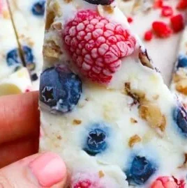 Homemade frozen yogurt bark topped with fruits and nuts