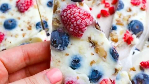 Homemade frozen yogurt bark topped with fruits and nuts