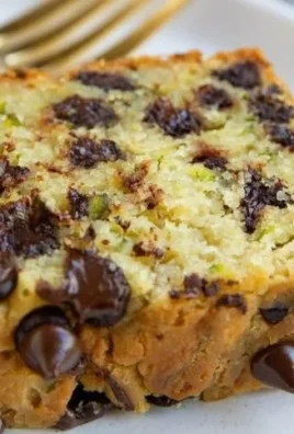 Loaf of gluten-free zucchini bread with slices on a wooden board
