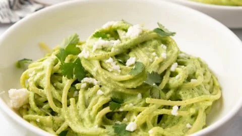 Plate of Green Spaghetti topped with creamy poblano sauce and herbs.