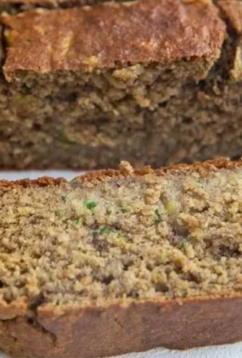 Healthy oatmeal zucchini banana bread slice topped with walnuts