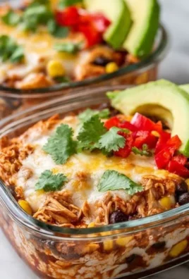 High-protein chicken enchilada bowls topped with cottage cheese and garnished.