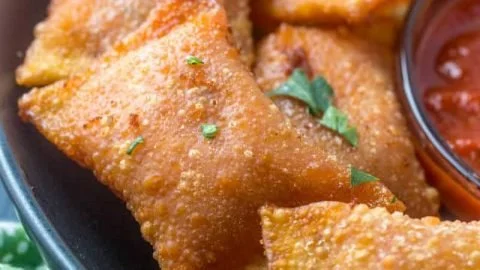 Homemade pizza rolls filled with cheese and pepperoni, served on a plate.