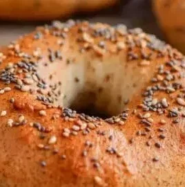 Delicious homemade protein bagels on a wooden board with toppings