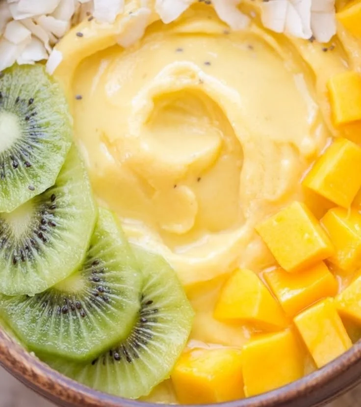 Mango Pineapple Smoothie Bowl topped with fresh fruit and nuts