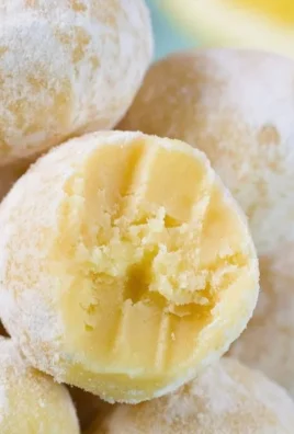No bake lemon truffles dessert on a white plate with lemon slices