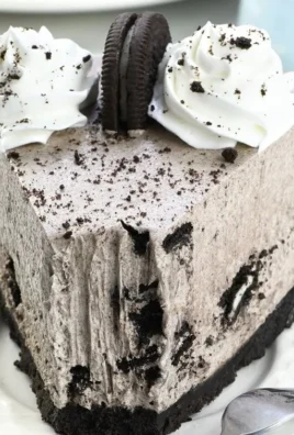 Delicious No-Bake Oreo Cheesecake topped with crushed Oreos and chocolate drizzle