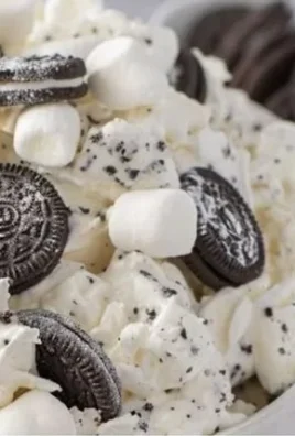 Bowl of creamy Oreo Fluff dessert with crushed Oreos and whipped cream