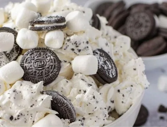 Bowl of creamy Oreo Fluff dessert with crushed Oreos and whipped cream