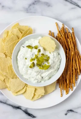 Creamy and tangy pickle dip served in a bowl with dipping chips