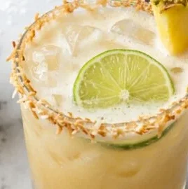 Pineapple Coconut Mockarita served in a glass with tropical garnishes