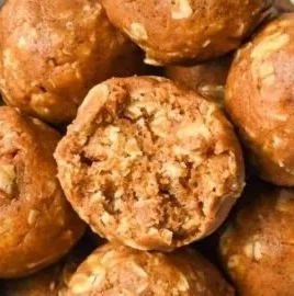 Homemade pumpkin protein balls with nuts and seeds on a wooden table