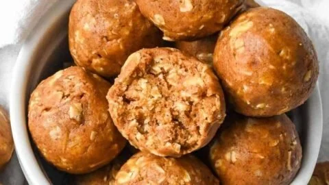 Homemade pumpkin protein balls with nuts and seeds on a wooden table