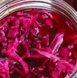 Quick pickled red cabbage in a jar, ideal for salads and garnishes.