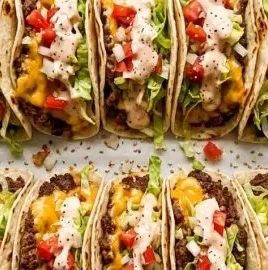 Delicious smash burger tacos topped with fresh ingredients and served on a plate.