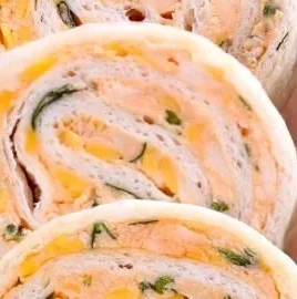 Plate of delicious Taco Tortilla Roll Ups served with dipping sauce